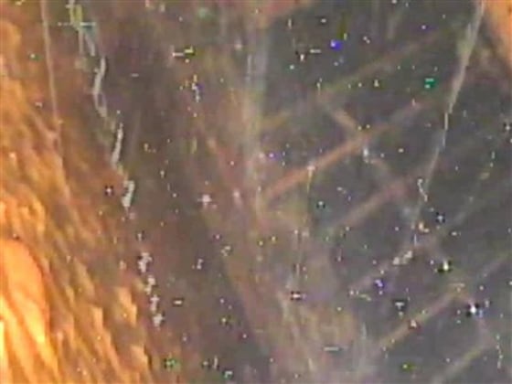 This photo taken by a remote-controlled endoscope and released by Tokyo Electric Power Co. (TEPCO) shows a scaffolding, bottom, and the wall inside the beaker-shaped containment vessel of No. 2 reactor at the damaged Fukushima Dai-ichi nuclear power plant on Thursday.